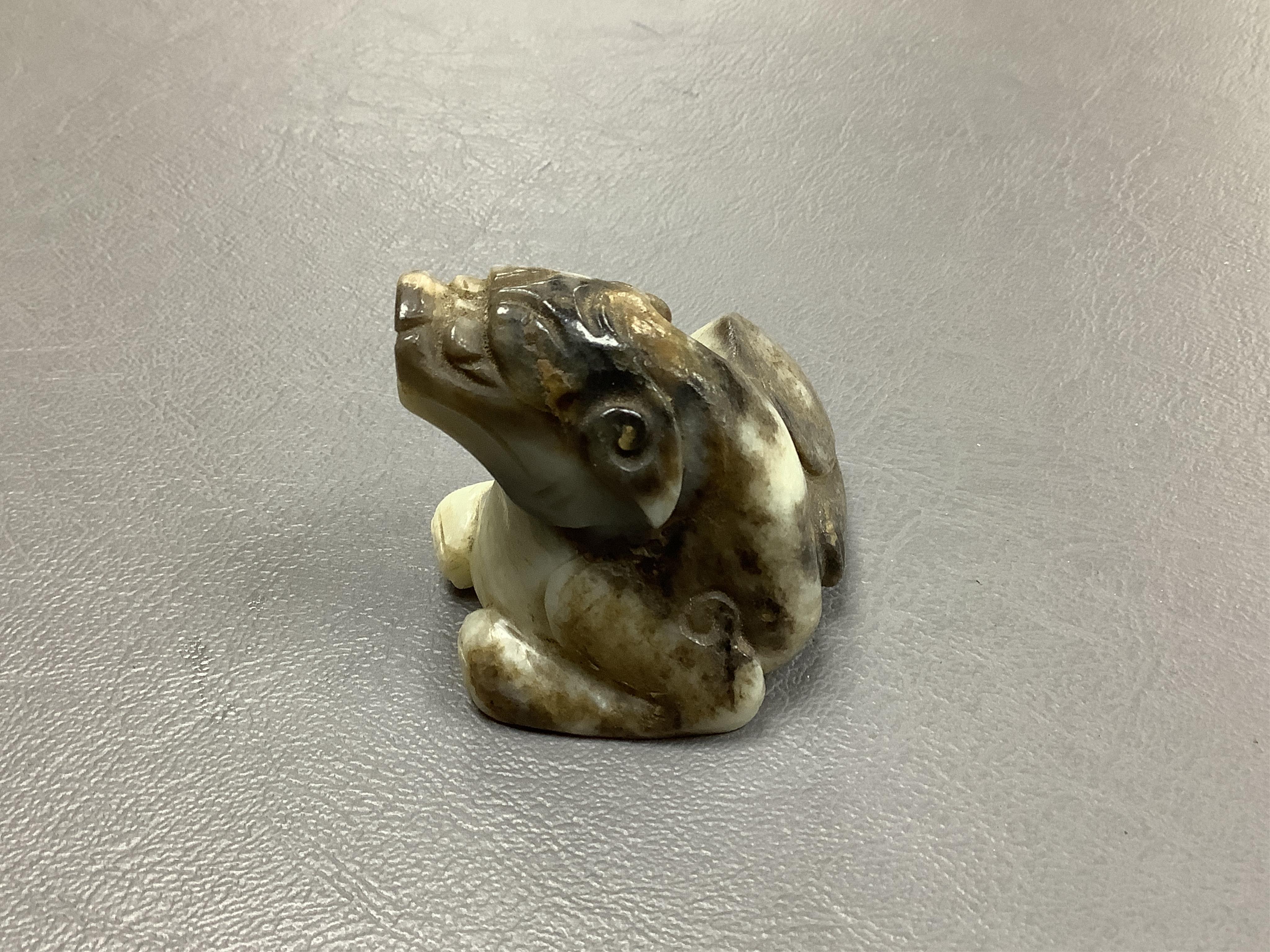 A Chinese white and black jade mythical beast, 5cm wide